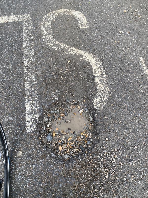 Large pothole with debris -School House Honeywell School, 58 Honeywell Road, London, SW11 6EF