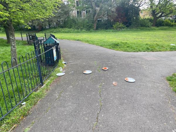 Litter all over pavement and grass area from bin-Downhills Park