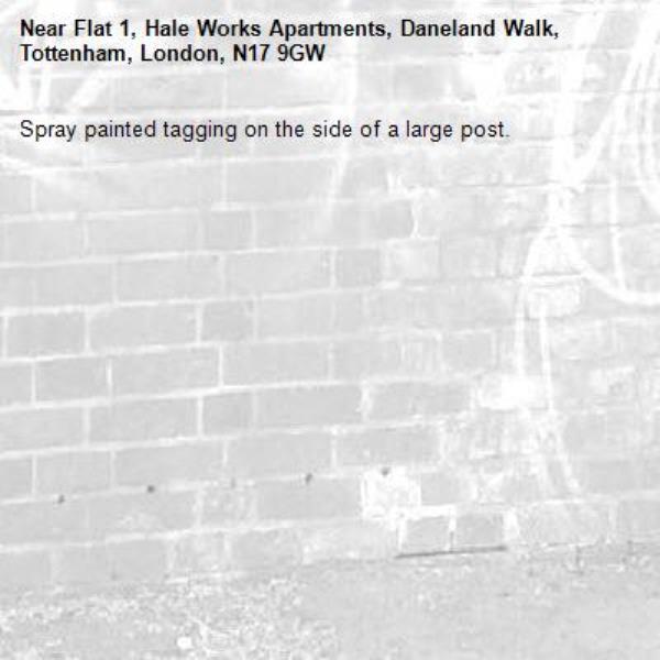 Spray painted tagging on the side of a large post.-Flat 1, Hale Works Apartments, Daneland Walk, Tottenham, London, N17 9GW