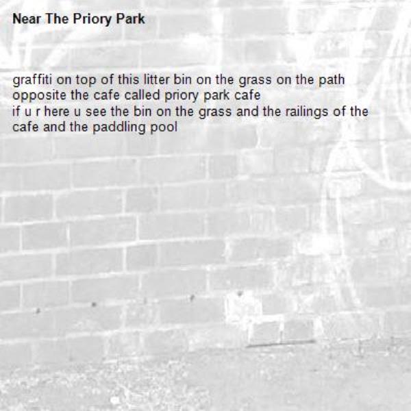 graffiti on top of this litter bin on the grass on the path opposite the cafe called priory park cafe
if u r here u see the bin on the grass and the railings of the cafe and the paddling pool-The Priory Park