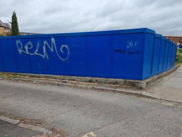 Grafitti on blue hoarding -Station Bridge Site Of Kebab Shop South Road, London, UB1 1SU