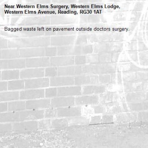 Bagged waste left on pavement outside doctors surgery.-Western Elms Surgery, Western Elms Lodge, Western Elms Avenue, Reading, RG30 1AT