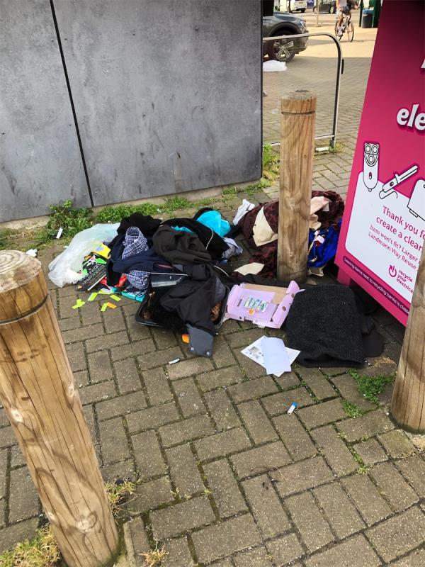 Junction of Lewisham High Street. Please clear flytip of clothing from beside Electrical bank-69 Longbridge Way, Hither Green, London, SE13 6PW