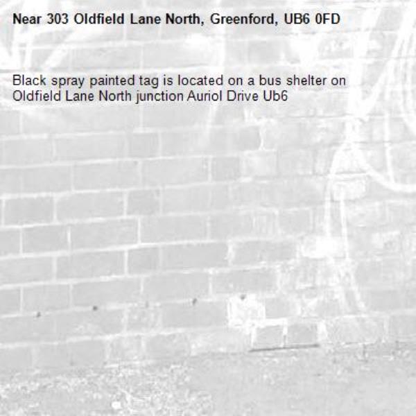 Black spray painted tag is located on a bus shelter on Oldfield Lane North junction Auriol Drive Ub6 -303 Oldfield Lane North, Greenford, UB6 0FD