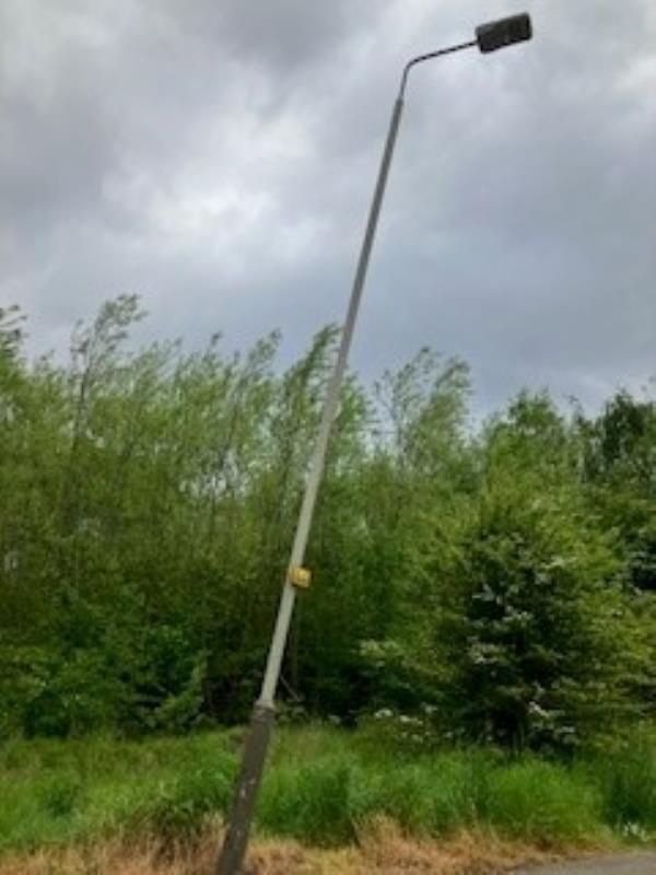A STREET LIGHT HAS BEEN HIT AND IS LEANING AT A VERY PRECARIOUS ANGLE. I CANNOT SEE A NUMBER ON IT, BUT IT IS DIRECTLY OPPOSITE THE GATEHOUSE OF SIFIDEL UK LTD-Hilltop Road, Leicester