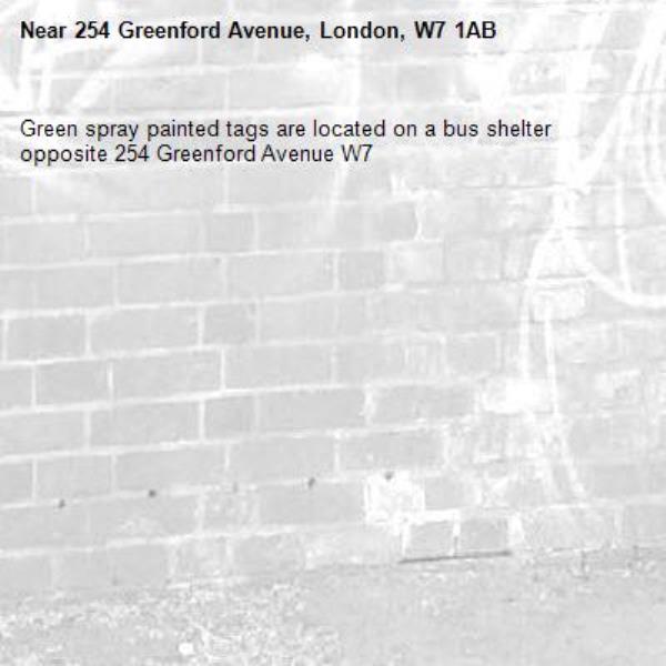 Green spray painted tags are located on a bus shelter opposite 254 Greenford Avenue W7 -254 Greenford Avenue, London, W7 1AB