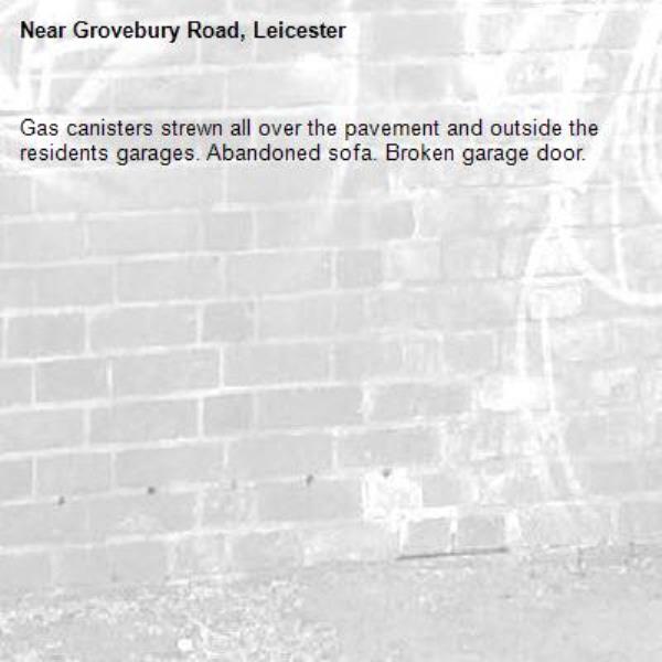 Gas canisters strewn all over the pavement and outside the residents garages. Abandoned sofa. Broken garage door.-Grovebury Road, Leicester