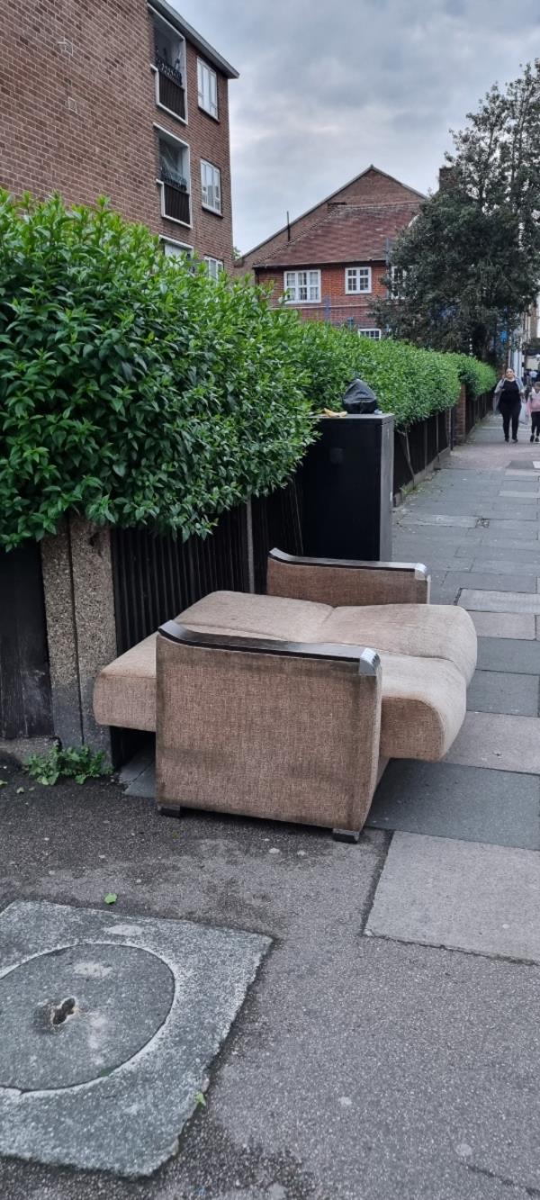 Double seater sofa / bed left on the pavement of high street north in Manor Park opposite Greenhill Centre new development and close to the school-467 High Street North, Manor Park, London, E12 6TH