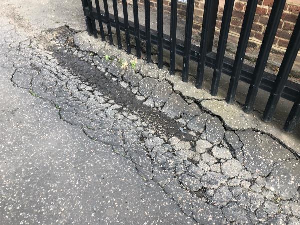 Service Road to side of 34-44 . Badly rutted and breaking up by entrance gate-44 Crutchley Road, London, SE6 1QL