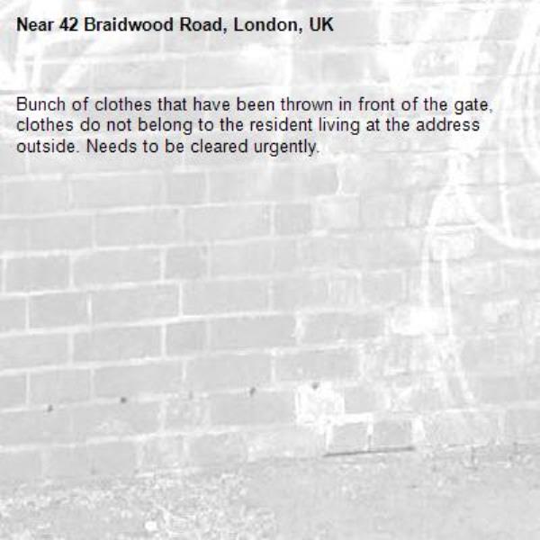 Bunch of clothes that have been thrown in front of the gate, clothes do not belong to the resident living at the address outside. Needs to be cleared urgently.-42 Braidwood Road, London, UK