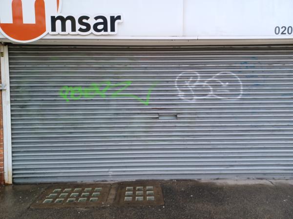 Unsightly graffiti on shutters  -273 Kirkdale, London, SE26 4QD