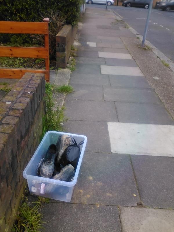 plastic box of shoes and rubbish on pavement near 97 College Park Close-97 College Park Close
