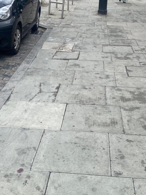 Cracked paving, parts missing and slabs sticking up and rocking. Been like this since before covid lockdown. Reported numerous times without repairs. Just white spray paint -55 Woodgrange Road, London, E7 0EL