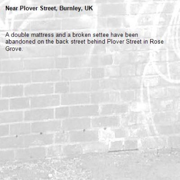 A double mattress and a broken settee have been abandoned on the back street behind Plover Street in Rose Grove.-Plover Street, Burnley, UK