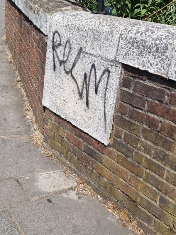 Grafitti on wall by bus stop near station-South Road, London, UB2 4AU