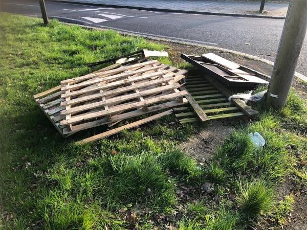 Woodbank Road junction of Shaw Road. Please clear wooden fencing from grass area-Play Space