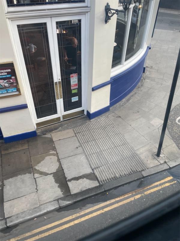 Blocked gully drain is located outside The Red Lion and Pineapple Gunnerbury Lane junction High Street w3 -The Red Lion & Pineapple, Red Lion And Pineapple, 281 High Street, Acton, W3 9BP