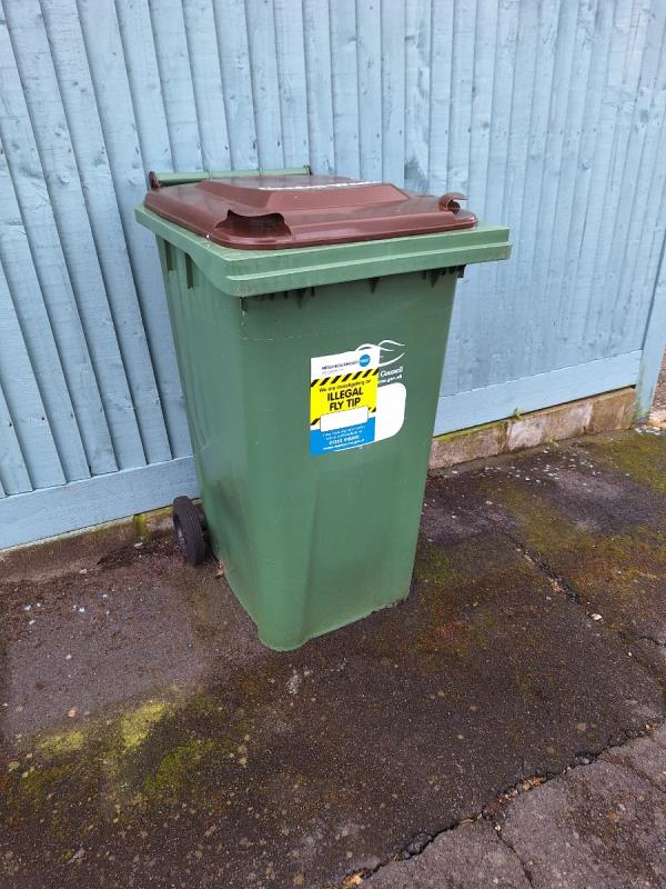 This is a contaminated green waste bin that needs removing from the side of 116 Hythe Crescent Seaford -118 Hythe Crescent, Seaford, BN25 3UG