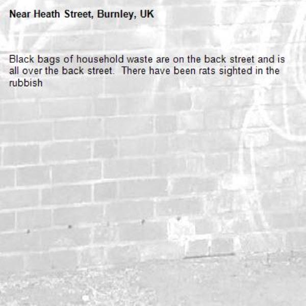 Black bags of household waste are on the back street and is all over the back street.  There have been rats sighted in the rubbish-Heath Street, Burnley, UK