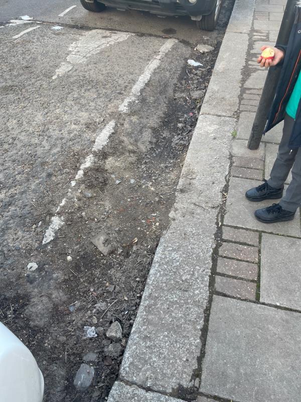 This lump of concrete on the hump prevents water from raining causing a back log of stagnant water. This has been reported on a number of occasions -89 West Road, West Ham, E15 3PX, England, United Kingdom