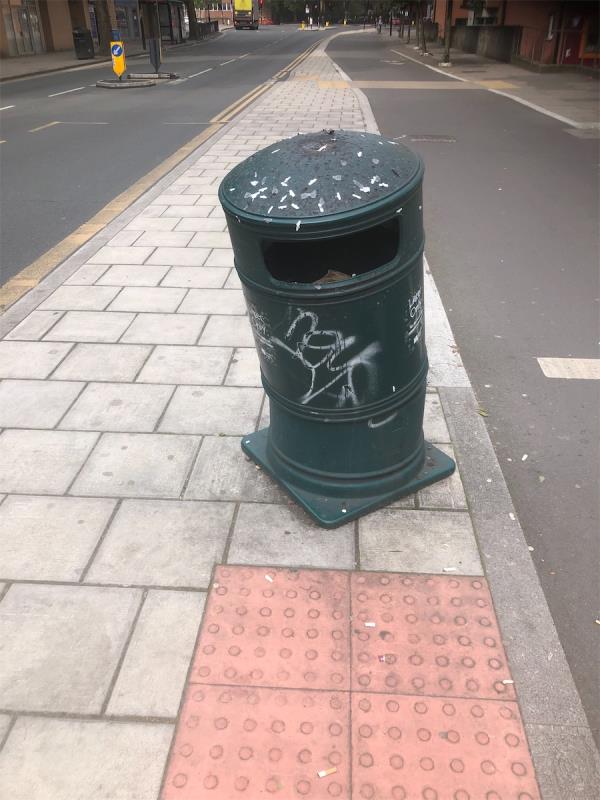 Outside Margaret McMillian Campus and Sainsbury Local. Remove graffiti from litter bin-Creek Road, Deptford