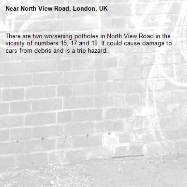 There are two worsening potholes in North View Road in the vicinity of numbers 15, 17 and 19. It could cause damage to cars from debris and is a trip hazard. -North View Road, London, UK
