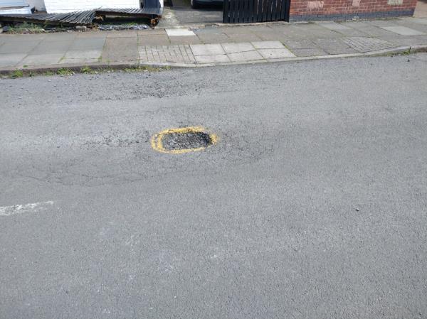 Pothole reopened after previous repair. -10 Stokes Drive, Leicester, LE3 9BR