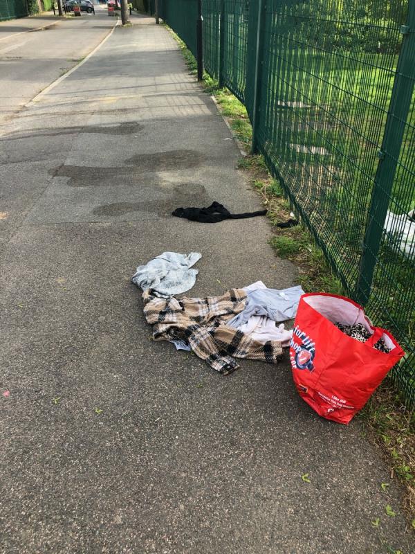 Please clear dumped bag of clothing from outside playing fields-94 Glenbow Road, Bromley, BR1 4NL