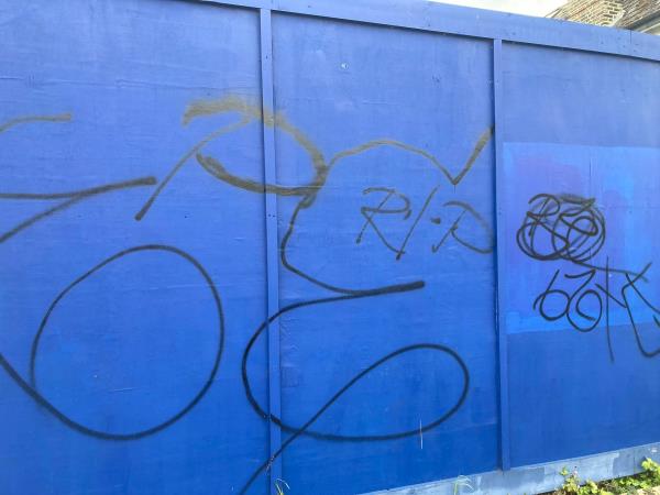 Graffiti on the blue hoardings by Berryman’s Lane. -46 Mayow Road, London, SE26 4JA