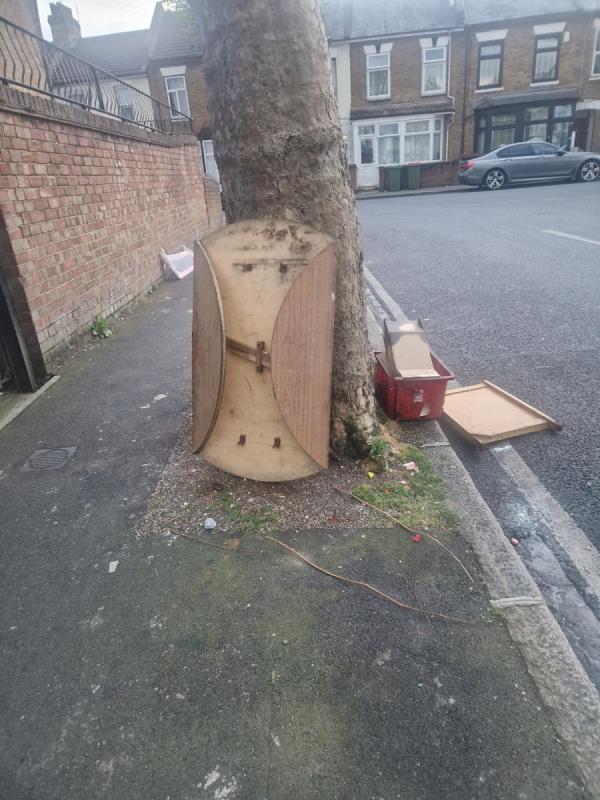 Rubbish dumped on pavement by tree -59 Lansdown Road, Forest Gate, London, E7 8NF