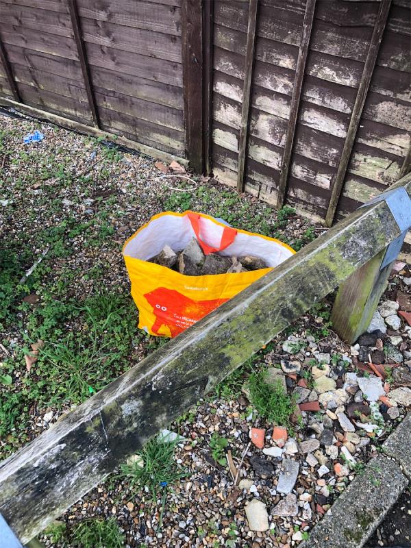 Junction of Downderry Road. Please clear a bag full of concrete from corner plot-9 Shroffold Road, Bromley, BR1 5PD