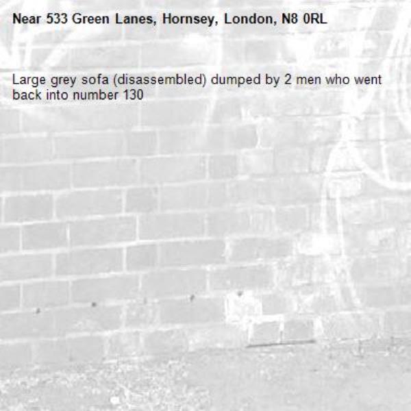 Large grey sofa (disassembled) dumped by 2 men who went back into number 130-533 Green Lanes, Hornsey, London, N8 0RL