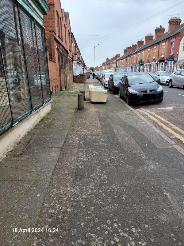 Sofa dumped in pathway-237 Melton Road, Leicester, LE4 7AN