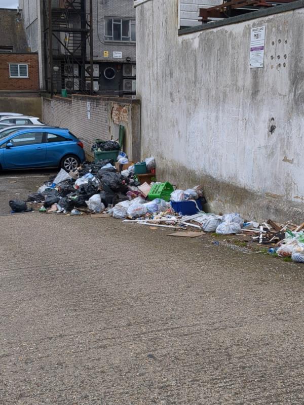 A huge pile of rubbish at the car park at the rear of Rose Court, accessed via Birchett Road -Rose Court, 105 Victoria Road, Aldershot, GU11 1JE