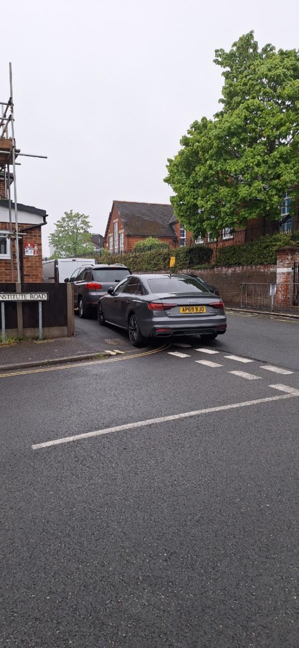 2 cars AP69BJO and AE15XCH are parked on the corner of Newport Road and Institute Road, Aldershot.  The Audi AP69BJO is overhanging the junction into Institute Road. This is causing an obstruction and also a visible obstruction. 
These owners of these 2 vehicles continually use the double yellow lines and no waiting kerb marks areas as their own personal parking space. -35 Institute Road, Aldershot, GU12 4DA