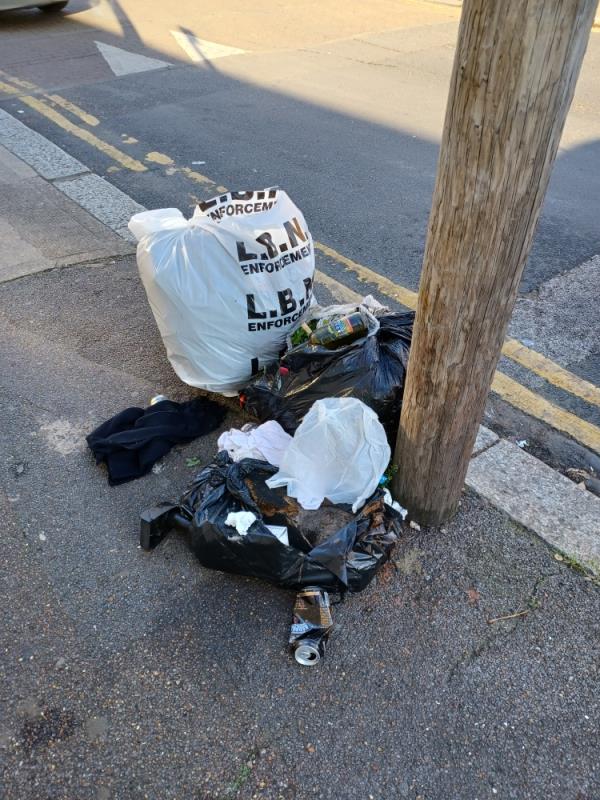 Rubbish fly tipped by a pole on pavement, Stukeley Road, E7 opposite Falconwood Court, E7.-164 Boleyn Road, Forest Gate North, E7 9QJ, England, United Kingdom