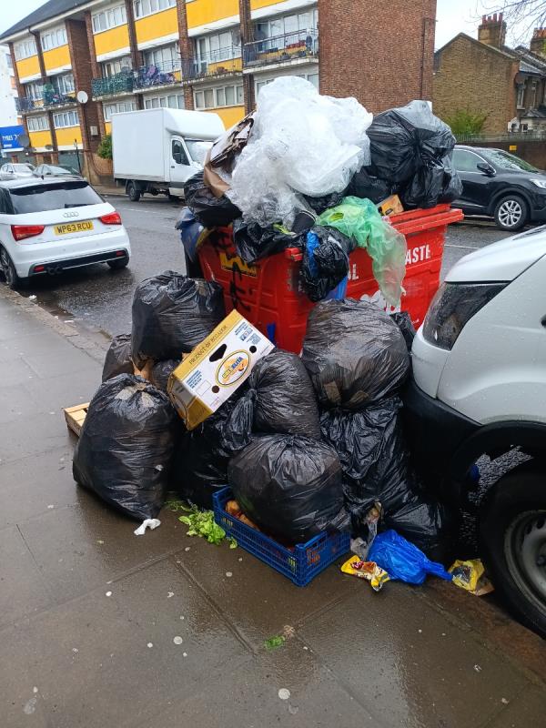 Large red waste bin overflowing -China Express, 157 Plaistow Road, Stratford, London, E15 3ET